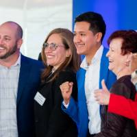 Group of event guests standing in line and smiling off camera
